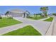 Well-maintained home featuring a spacious driveway, lush lawn, and mature landscaping at 13160 Golden Lime Ave, Spring Hill, FL 34609