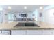 Kitchen island with a sink and views into the living room featuring a TV and comfortable seating at 13160 Golden Lime Ave, Spring Hill, FL 34609