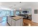 Open-concept kitchen with an island, stainless steel appliances, and connection to the dining and living areas at 13160 Golden Lime Ave, Spring Hill, FL 34609