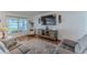 Well-lit living room featuring a gray sofa, accent rug, and stylish decor at 13160 Golden Lime Ave, Spring Hill, FL 34609
