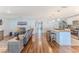 Open-concept living area with wood floors, a kitchen, and comfortable seating at 13160 Golden Lime Ave, Spring Hill, FL 34609