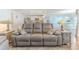 Open-concept living space with a gray sofa, showcasing seamless flow to the kitchen at 13160 Golden Lime Ave, Spring Hill, FL 34609
