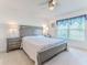 Serene main bedroom with gray furniture, ceiling fan, and natural light from the window at 13160 Golden Lime Ave, Spring Hill, FL 34609