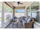 A screened in patio features a ceiling fan, outdoor furniture and views of the fenced backyard and grilling area at 13160 Golden Lime Ave, Spring Hill, FL 34609