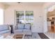 A screened in lanai features outdoor seating and access to the kitchen, with views of the backyard and fence at 13160 Golden Lime Ave, Spring Hill, FL 34609