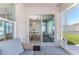A screened in lanai with sliding glass doors leading to the dining room, plus a view of the green lawn at 13160 Golden Lime Ave, Spring Hill, FL 34609
