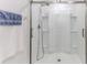 Glass enclosed shower with towel rack and white shower panels at 13160 Golden Lime Ave, Spring Hill, FL 34609