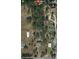 Aerial view of the property, showing the layout, trees, and surrounding landscape at 13377 Montour St, Brooksville, FL 34613