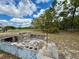 Backyard with a square fire pit is ideal for hosting gatherings and enjoying cozy evenings at 13377 Montour St, Brooksville, FL 34613