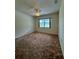 This bedroom has a ceiling fan and a window providing natural light at 13377 Montour St, Brooksville, FL 34613