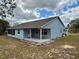 Back exterior view with a covered back patio area. Perfect for relaxing and enjoying the outdoors at 13377 Montour St, Brooksville, FL 34613