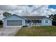 Charming single-story home with a well-maintained lawn, a one car garage and a covered porch at 13377 Montour St, Brooksville, FL 34613