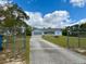 A nice single-story light blue home with a screened garage and front porch at 13377 Montour St, Brooksville, FL 34613