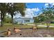 A single-story light blue home with nice landscaping and front yard decorations at 13377 Montour St, Brooksville, FL 34613