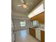 Kitchen with wooden cabinets with breakfast bar looking to the living room at 13377 Montour St, Brooksville, FL 34613