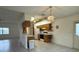 Open-concept kitchen with view to living room, featuring wooden cabinets and breakfast bar at 13377 Montour St, Brooksville, FL 34613