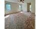 Spacious main bedroom features two windows and ceiling fan, providing natural light and comfortable airflow at 13377 Montour St, Brooksville, FL 34613