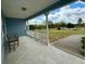 Covered front porch with white railings, a bench, and a view of the outdoors at 13377 Montour St, Brooksville, FL 34613