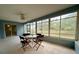 Cozy sunroom features a ceiling fan and large windows to enjoy the peaceful outdoor scenery at 13377 Montour St, Brooksville, FL 34613