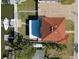 Overhead view showcasing boat, dock and boatlift of a waterfront property with expansive brick driveway and lush landscaping at 13741 Judy Ave, Hudson, FL 34667