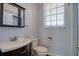 Well-lit half bathroom with a modern sink and toilet at 13741 Judy Ave, Hudson, FL 34667