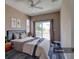 Cozy bedroom with a ceiling fan, balcony, and neutral-toned decor at 13741 Judy Ave, Hudson, FL 34667