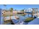 Well-maintained boat dock featuring a boat lift, clear canal waters, and convenient access to waterfront living at 13741 Judy Ave, Hudson, FL 34667