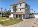 Three-story home with lush landscaping, a paver driveway, and a three-car garage at 13741 Judy Ave, Hudson, FL 34667