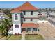 Stunning three-story waterfront home featuring a brick driveway, well-manicured landscaping, and a charming front porch at 13741 Judy Ave, Hudson, FL 34667