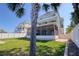 Exterior view of a multi-story home featuring multiple balconies and a screened-in patio at 13741 Judy Ave, Hudson, FL 34667