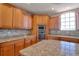 Kitchen with granite countertops, stainless appliances, a tile backsplash, and wood cabinets at 13741 Judy Ave, Hudson, FL 34667