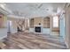 Open-concept living room with a fireplace, built-in shelves, wood floors, and natural light at 13741 Judy Ave, Hudson, FL 34667