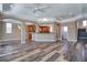 Open-concept living room with wood floors, ceiling fans, and an open view of the kitchen at 13741 Judy Ave, Hudson, FL 34667