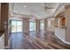 Bright living room featuring hardwood floors, modern furniture, and sliding doors to the balcony at 13741 Judy Ave, Hudson, FL 34667