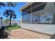 Enclosed patio with tile floor, ceiling fan, and palm tree view at 13741 Judy Ave, Hudson, FL 34667