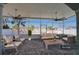 Screened-in patio featuring brick floors, ceiling fans, and comfortable furniture with lovely waterfront views at 13741 Judy Ave, Hudson, FL 34667