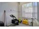 Storage room with a window, ample storage space, and a well-organized setup for lawn equipment at 13741 Judy Ave, Hudson, FL 34667