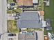 Aerial view of a light blue home featuring a large roof, dock, and backyard deck at 13815 Plumosa Ave, Hudson, FL 34667