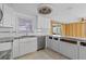 Bright kitchen features white cabinets and modern appliances at 13815 Plumosa Ave, Hudson, FL 34667