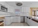 Bright kitchen features white cabinets and modern appliances at 13815 Plumosa Ave, Hudson, FL 34667