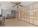 Open-concept living space featuring retro-style flooring and fan, ready for renovation at 13815 Plumosa Ave, Hudson, FL 34667