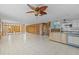 Large room with light flooring ready for customization and renovation at 13815 Plumosa Ave, Hudson, FL 34667