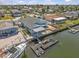 Aerial view of the back of waterfront home featuring a floating dock and boat lift on a sunny day at 13815 Plumosa Ave, Hudson, FL 34667