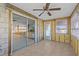 Sun room features tile flooring, fan, and sliders to the kitchen offering lots of light at 13815 Plumosa Ave, Hudson, FL 34667
