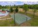 Well-maintained basketball court surrounded by green space and a playground at 16022 Westerham Dr, Tampa, FL 33647