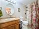 Standard bathroom featuring a vanity, toilet, shower and decorative floral curtain at 16022 Westerham Dr, Tampa, FL 33647