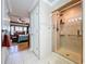 This bathroom features a walk-in shower with glass doors, complemented by tiled walls at 16022 Westerham Dr, Tampa, FL 33647