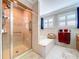 This bathroom features a walk-in shower and soaking tub, complemented by tiled walls at 16022 Westerham Dr, Tampa, FL 33647