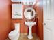 Powder room featuring a pedestal sink, white cabinetry, and a decorative mirror at 16022 Westerham Dr, Tampa, FL 33647