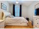 This bedroom features white furnishings and a shuttered window, creating a bright, airy space at 16022 Westerham Dr, Tampa, FL 33647